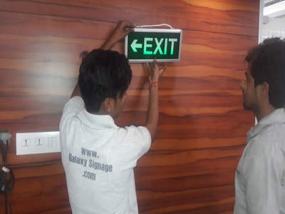 FIRE EXIT SAFETY BATTERY OPERATED SIGNAGE INSTALLED IN MARUTI COMPANY 